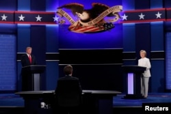 Republican U.S. presidential nominee Donald Trump and Democratic nominee Hillary Clinton begin their third and final 2016 presidential campaign debate at UNLV in Las Vegas, Nevada, Oct. 19, 2016.