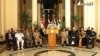 Lt. Gen. Abdel-Fattah el-Sissi, center, flanked by military and civilian leaders addresses the nation on Egyptian state television, July 3, 2013. 