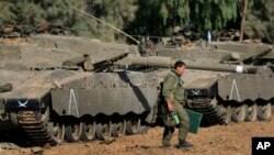 Opening day at Cairo’s Birqash camel market. In the pre-dawn hours, a boy – stick in hand – keeps camels in place for the start of a busy trading day.