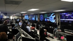 FILE - U.S. Department of Homeland Security election security workers monitor screens in Arlington, Va., Nov. 6, 2018.