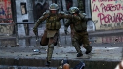 在智利首都圣地亚哥的一次反政府示威期间，防暴警察与抗议者冲突。(2019年12月14日)