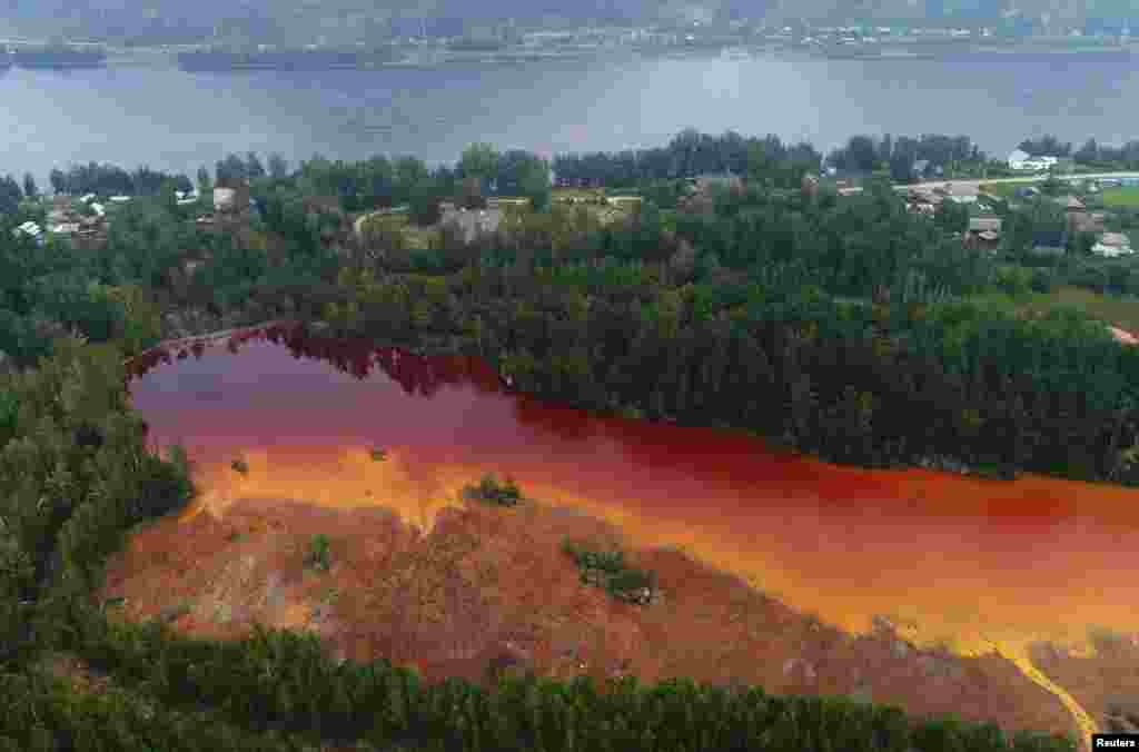 A view of a reservoir tainted with waters from a closed copper mine, on a bank of the Yenisei River in the Siberian settlement of Maina, Khakassia, Russia, July 23, 2019.