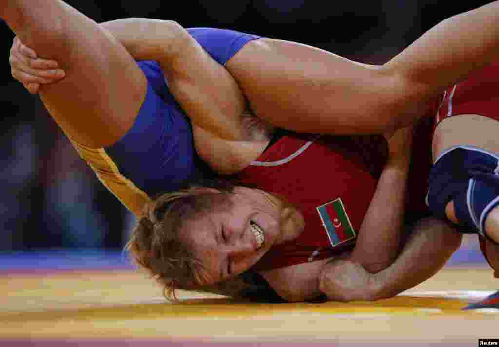 Yuliya Ratkevi&ccedil; (qırmızı) 55 kq-da g&uuml;ləşir. London onun &uuml;&ccedil;&uuml;n b&uuml;r&uuml;nc medalla yadda qalır.