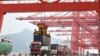 A crane loads a container onto a truck at Lianyungang Port in Lianyungang in China's eastern Jiangsu province on September 7, 2021.