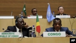 Front row, left to right, Joseph Kabila Kabange President of the Democratic Republic of Congo, and Denis Sanssou N'guesso, President of the Republic of Congo, during the signing of the Congo peace deal in Addis Ababa, Ethiopia, Feb. 24, 2013. 