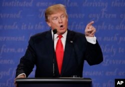 Republican presidential nominee Donald Trump speaks to Democratic presidential nominee Hillary Clinton during the third presidential debate at UNLV in Las Vegas, Oct. 19, 2016.