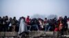 Migrants gather to gain entrance to Austria, at the Slovenian Austrian border, in Sentilj, Slovenia, Nov. 3, 2015. Austria Tuesday proposed a tough new bill to deter Afghans that the U.N. refugee agency criticized as likely to increase the migrants' suffe