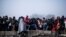Migrants gather to gain entrance to Austria, at the Slovenian Austrian border, in Sentilj, Slovenia, Nov. 3, 2015. Austria Tuesday proposed a tough new bill to deter Afghans that the U.N. refugee agency criticized as likely to increase the migrants' suffe