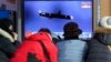FILE - People watch a TV showing a file image of North Korea's missile launch during a news program at the Seoul Railway Station in Seoul, South Korea, Jan. 25, 2022.