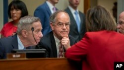 Rep. Jim Cooper, D-Tenn. (C), and Rep. Stephen F. Lynch, D-Mass. (L), confer with other Democrats as the House Oversight and Reform Committee considers whether to hold Attorney General William Barr and Commerce Sec. Wilbur Ross in contempt, June 12, 2019.