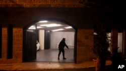 A security guard stands in the garage at the residence of former Nissan Chairman Carlos Ghosn on Monday, Dec. 30, 2019 in Beirut, Lebanon.