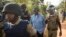 Uganda's main opposition leader Kizza Besigye, center, is arrested by police and thrown into the back of a blacked-out police van which whisked him away and was later seen at a rural police station, outside his home in Kasangati, Uganda Monday, Feb. 22, 2016.
