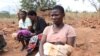A teenage mother sits with other women, in Phalombe district, Malawi. (Lameck Masina/VOA)