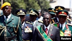 Zimbabwe's President Robert Mugabe arrives for the opening of parliament in Harare, Sept. 17, 2013.