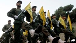 FILE - Hezbollah fighters parade in a southern suburb of Beirut, Lebanon, Nov. 12, 2010.