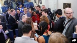 Reporters line up in hopes of attending a briefing in press secretary Sean Spicer's office at the White House in Washington, Feb. 24, 2017. The White House held an off-camera briefing in Spicer's office.
