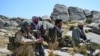 FILE - Afghan resistance movement and anti-Taliban uprising forces rest as they patrol on a hilltop in Darband area in Anaba district, Panjshir province, Sept. 1, 2021. 