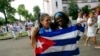 FILE - Recently released dissidents Haydee Gallardo (L) and Sonia Garro hold the Cuban national flag during a march in Havana, Jan. 11, 2015. 