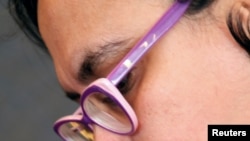 A volunteer wears a badge that reads "The power of labor aginst FGM", during a conference on International Day of Zero Tolerance for Female Genital Mutilation (FGM) in Cairo, Egypt February 6, 2018.