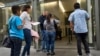 FILE - Immigrant families show paperwork to enter an immigration court in an office building in downtown Los Angeles, California, May 30, 2019.