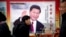 2018年3月2日，中国北京，人们走过展示中国国家主席习近平的宣传广告牌。