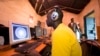 FILE - Young men surf the internet at a cyber cafe in Kibera slum in Nairobi, June 20, 2012.