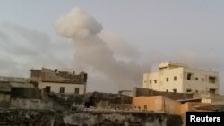 Smoke rises after car bombs explode in Mogadishu, Somalia, Feb. 23, 2018, in this still image taken from social media video.
