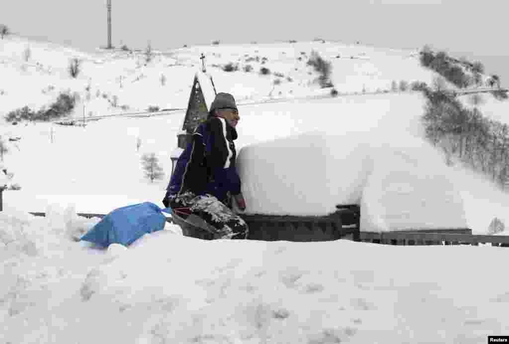 A man tries to open a garbage in in the village of Pajares, Spain.