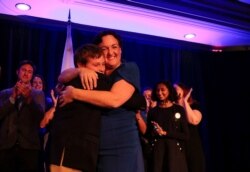 Democratic congressional candidate Katie Porter hugs her son at the end of her midterm election night party in Irvine, California, U.S. November 6, 2018.