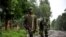 M23 rebel group soldiers patrol in Rangira, near Rutshuru, DRC, October 17, 2012.