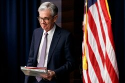 FILE - In this Dec. 11, 2019, file photo Federal Reserve Chair Jerome Powell arrives to speak at a news conference after the Federal Open Market Committee meeting in Washington.