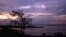 FILE - The sun sets over Lake George near Uganda's Queen Elizabeth National Park in western Uganda.