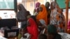 FILE - Women with their children wait to see doctors at a clinic operated by Doctors without Borders in Bagega village in northeastern state of Zamfara, Nigeria, Aug. 14, 2013. 