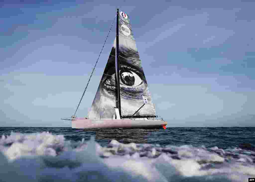 A picture taken during a training session off the coast of Le Havre, France, shows the "Vivo a Beira" monohull, Imoca, bearing a work by French street artist JR on the sail, prior to the start of the 13th Transat Jacques Vabre sailing race, from Le Havre to Salvador de Bahia in Brazil. The race will begin Nov. 5, 2017.