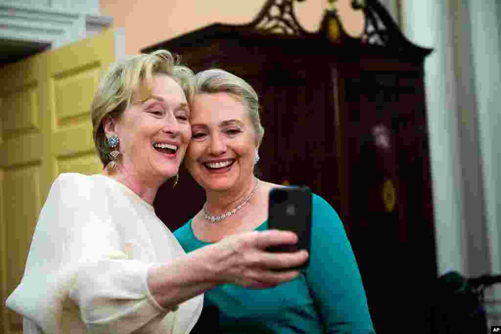 Actress Meryl Streep uses her iPhone to get a photo of her and Secretary of State Hillary Clinton following the Kennedy Center Honors gala in Washington, December 1, 2012.