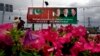 A Pakistani motorcyclist rides past a billboard showing pictures of Chinese President Xi Jinping, center, with Pakistan's President Mamnoon Hussain, left, and Prime Minister Nawaz Sharif welcoming Xi to Islamabad, Pakistan, April 19, 2015. 