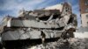 Men walk on the rubble of the Chamber of Trade and Industry headquarters after it was hit by a Saudi-led airstrike in Sanaa, Yemen, Jan. 5, 2016. 