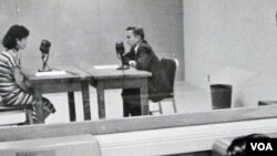 An early radio studio, from the perspective of the control room.