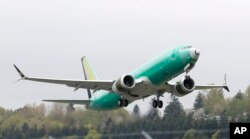 FILE - A Boeing 737 MAX 8 airplane being built for India-based Jet Airways, takes off on a test flight at Boeing Field in Seattle, April 10, 2019.