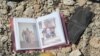 An family photo album lies among debris and blood where civilians were shot down by Islamic State snipers in early June, in Mosul, Iraq, June 15, 2017.