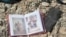 An family photo album lies among debris and blood where civilians were shot down by Islamic State snipers in early June, in Mosul, Iraq, June 15, 2017.