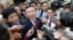 Cambodia's main opposition Cambodia National Rescue Party Deputy President and National Assembly Deputy President Kem Sokha, center, speaks to reporters outside the Phnom Penh Municipality Court in Phnom Penh, Cambodia, Wednesday, April 8, 2015. 