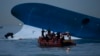 Maritime police search for missing passengers in front of the South Korean ferry that sank near Jindo, South Korea, April 16, 2014. 