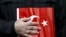 FILE - A supporter of Gulen movement holds a Turkey's national flag during a protest outside the Kanalturk and Bugun TV building in Istanbul, Turkey, Oct. 28, 2015. 