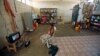 File- A boy watches TV in his family's shelter at a school in the southern Yemeni port city of Aden.