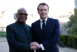 FILE - French President Emmanuel Macron, right, greets Mali's President Ibrahim Boubacar Keita prior to a meeting at the G5 Sahel summit in Pau, southwestern France, Jan.13, 2020.