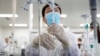 FILE - A man works in a laboratory of a Chinese vaccine maker, developing an experimental coronavirus disease vaccine, in Beijing, China, Sept. 24, 2020. 