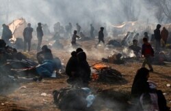 Migrants camp as they wait to cross the border, near Turkey's Pazarkule border crossing with Greece's Kastanies, in Edirne, Turkey, Feb. 29, 2020.