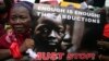 A woman holds a sign during a protest demanding the release of abducted secondary school girls from the remote village of Chibok, in Lagos, May 5, 2014.