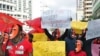 Masked sex workers march through the streets to demand access to government services, in Nairobi, Kenya, March 6, 2012.